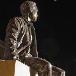 Neil Armstrong statue at night with full moon (Purdue University/ Mark Simons)